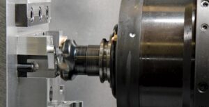 A face milling operation being performed on a horizontal machining center. This particular part has 7 required work planes in order to finish all the angled features and intersecting holes. ESPRIT's  simulation, as well as their robust post processors are required in order for the machinists to trust the programs. 